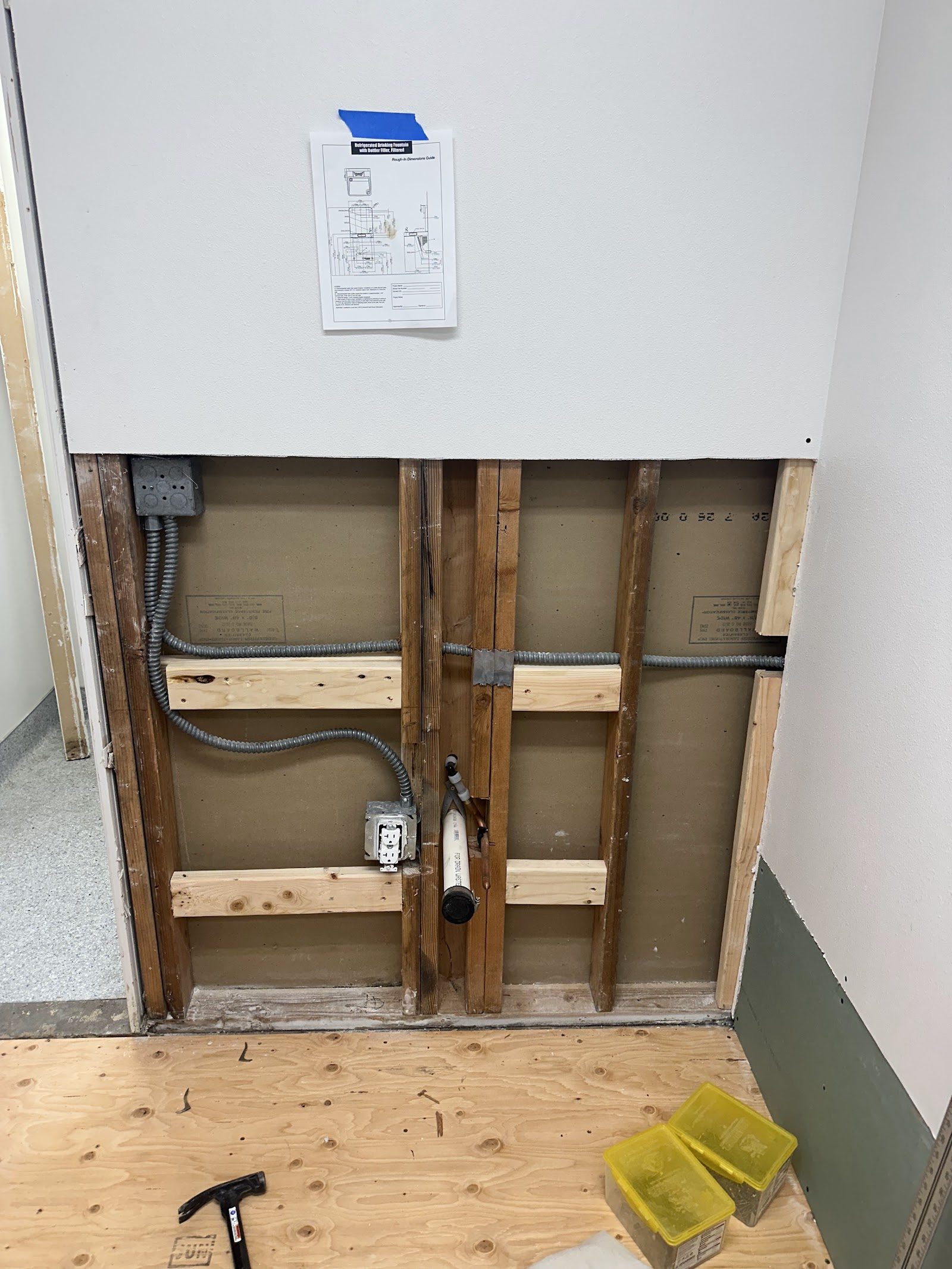 Wall opening with framing and plumbing below posted construction drawing