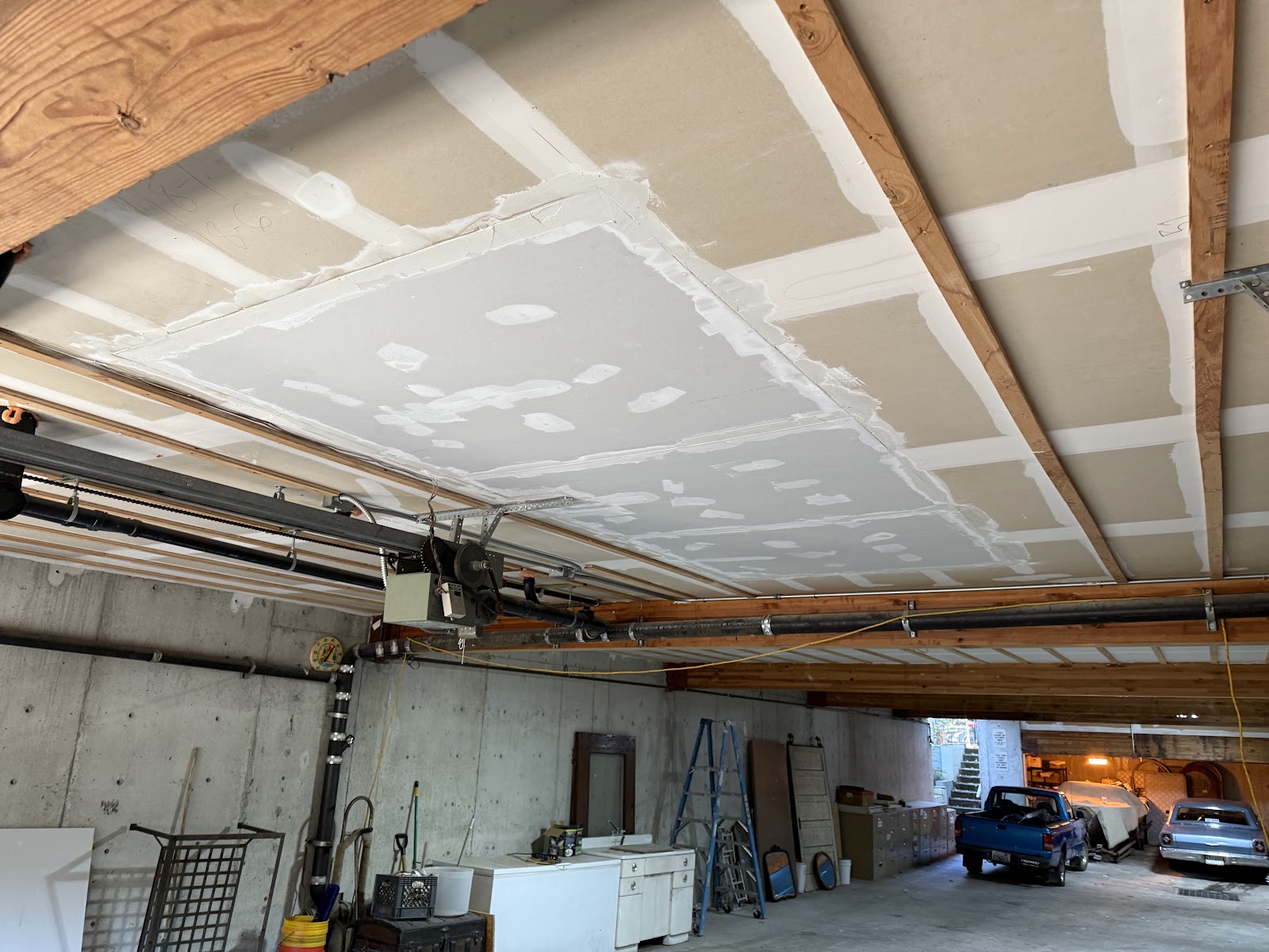 Wide view of the cleared space below with the repaired ceiling