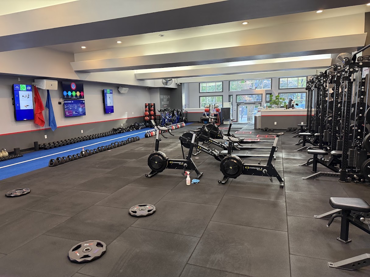 Refreshed F45 Queen Anne training floor with rowers, bikes, and strength racks