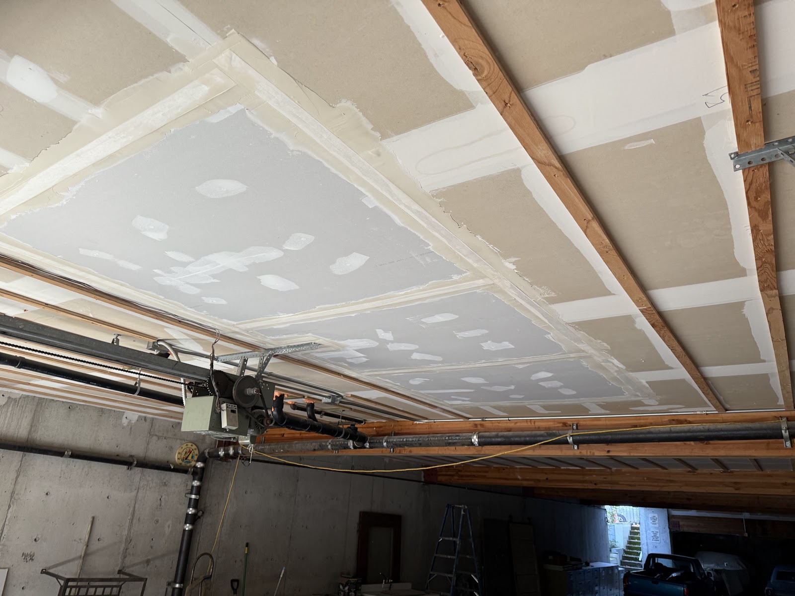 Patched ceiling with mudded seams and screw holes