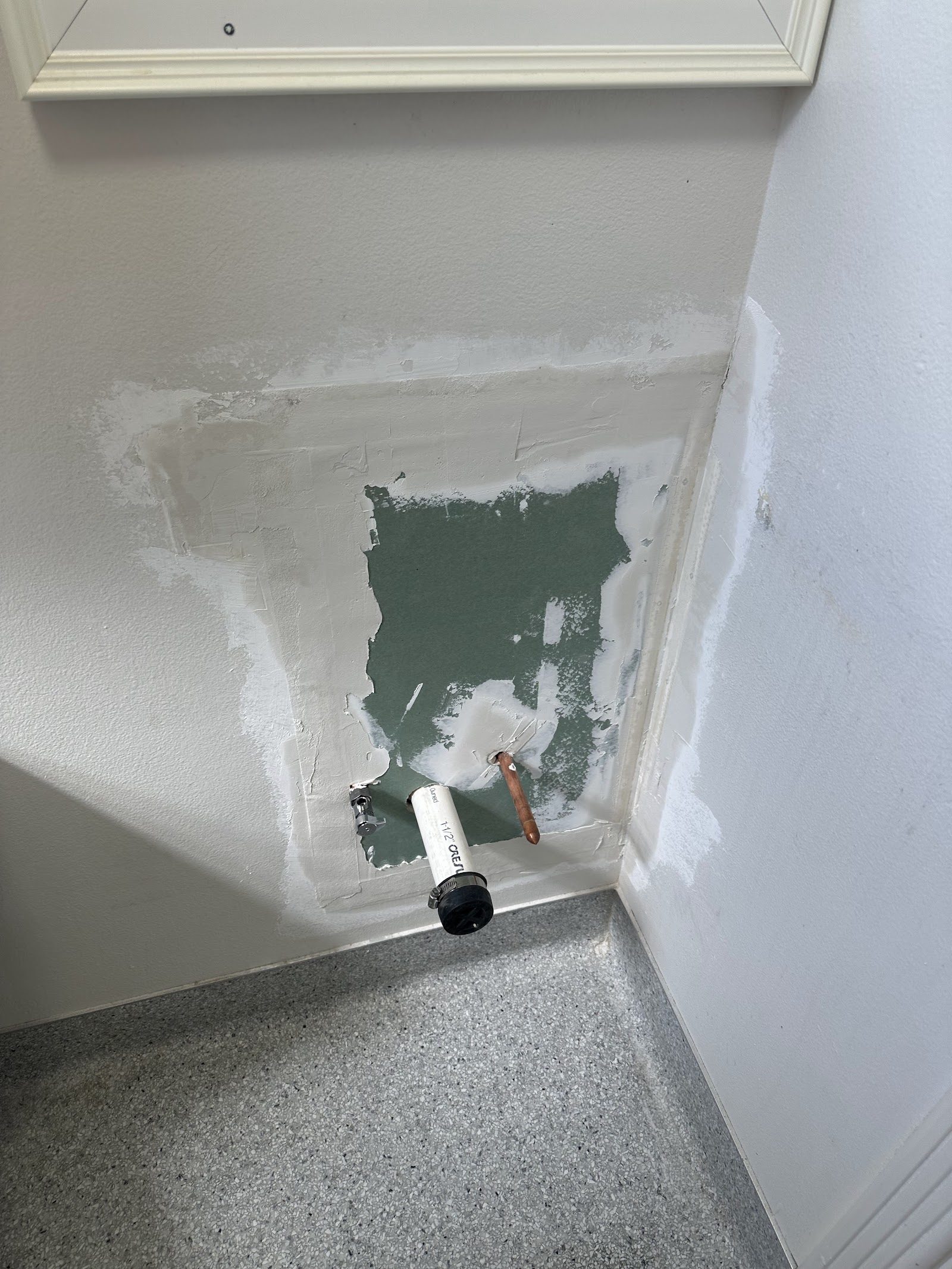 Patched wall with new water line stub at the fountain location
