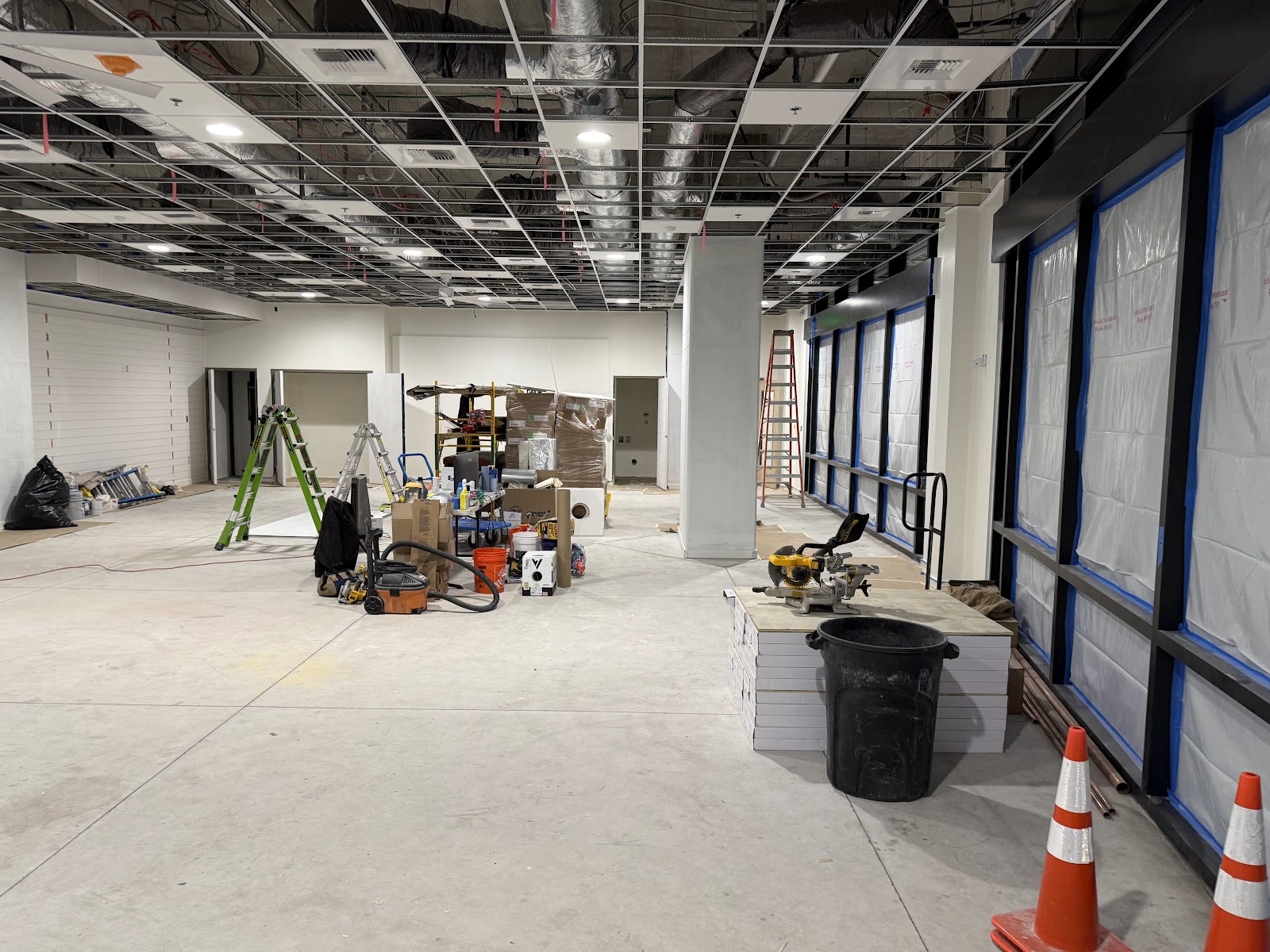 Gray-shell space during early construction with exposed structure and framing