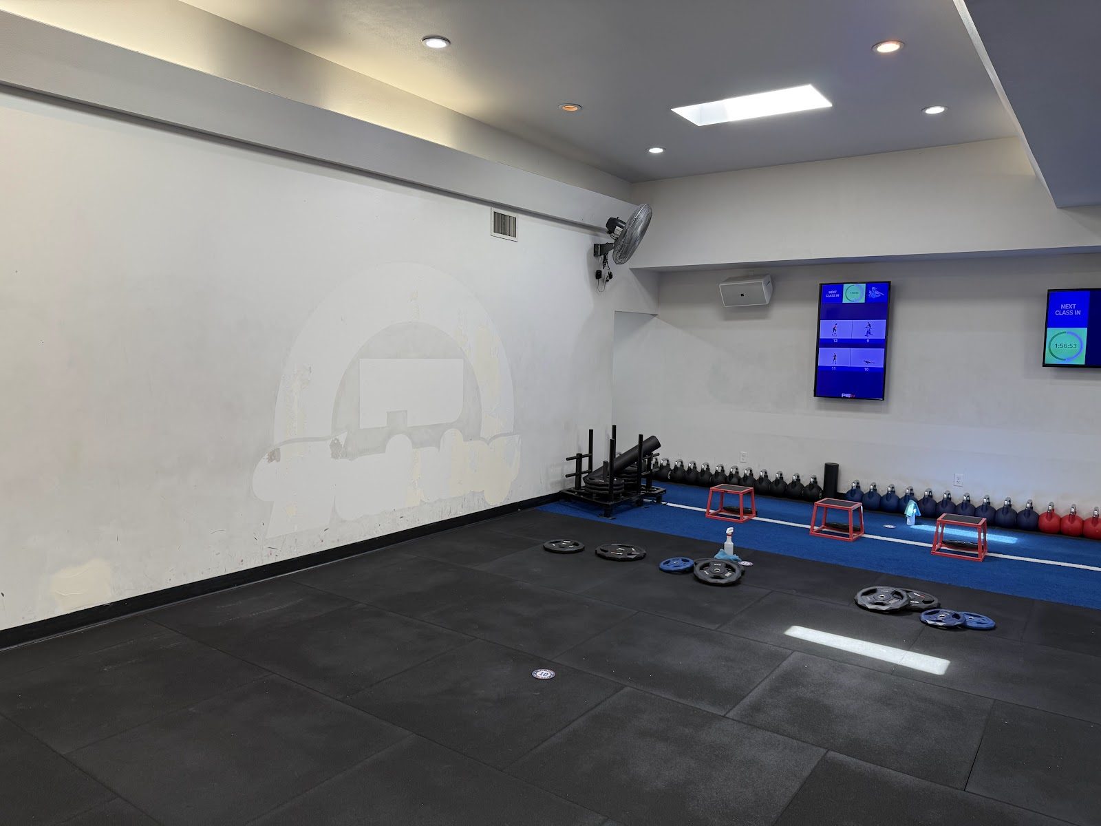 F45 Queen Anne training floor with repaired wall during prep