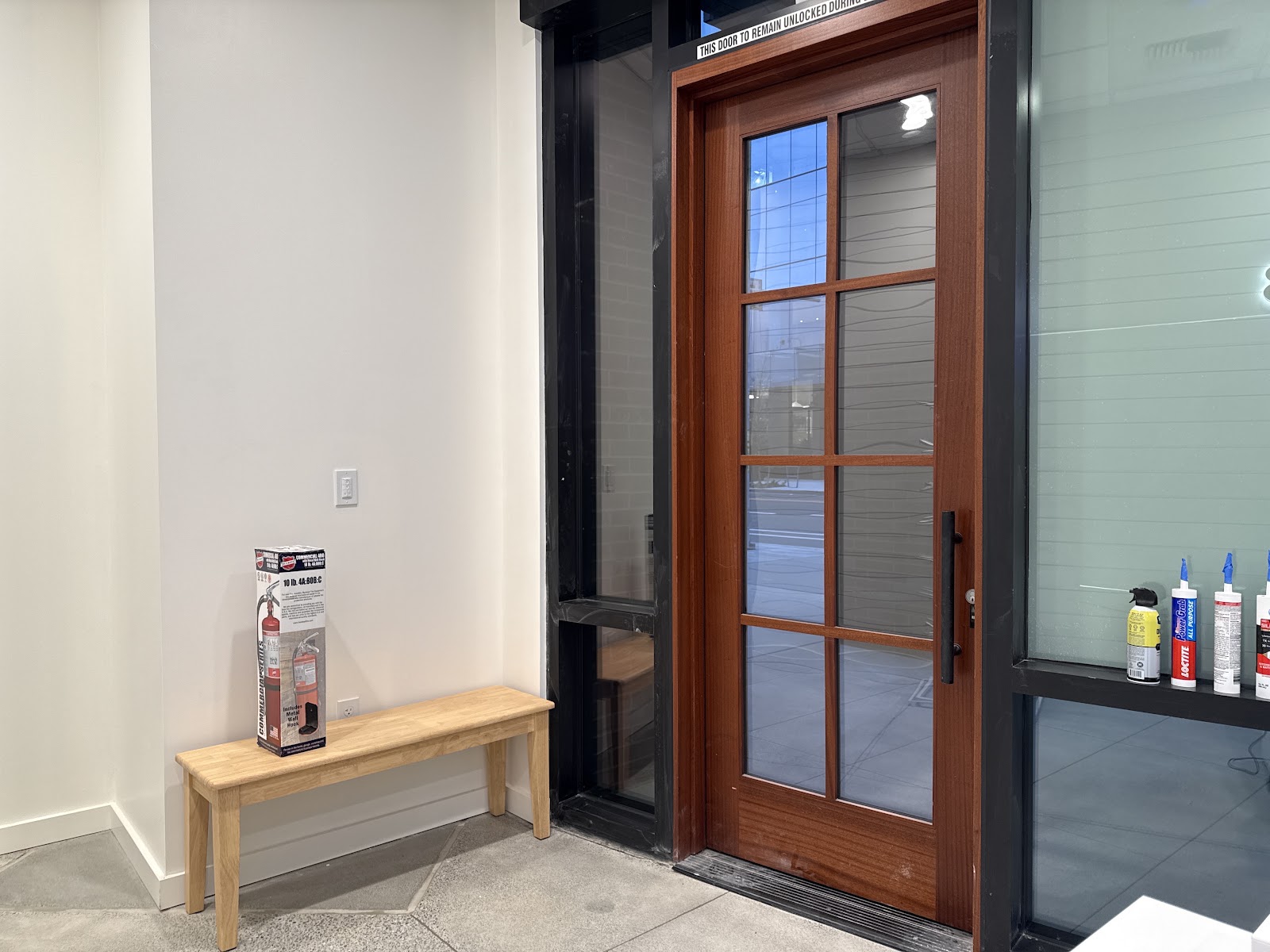 Entry bench and glazed timber door at the FS8 studio entrance