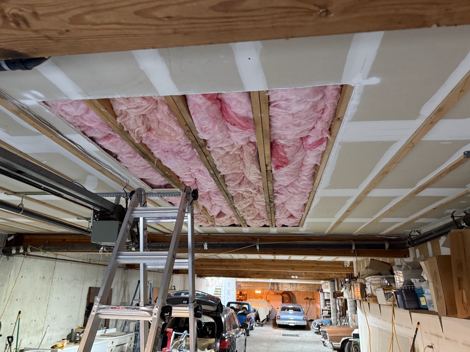 Ceiling section opened up showing insulation between joists